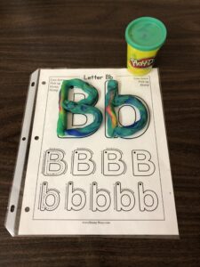 Roll playdough to build letters