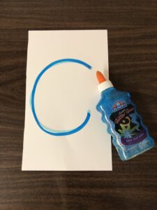 Squeeze glitter glue on paper or cards to improve letter formation