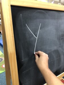 Use chalk on a vertical surface to write letters