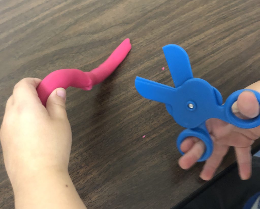 Plastic playdough scissors are a great for pre-cutting practice.