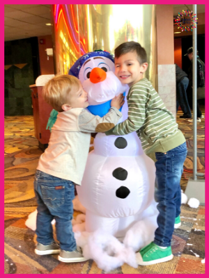 Kids hugging a character while going to see a movie on Christmas Day.