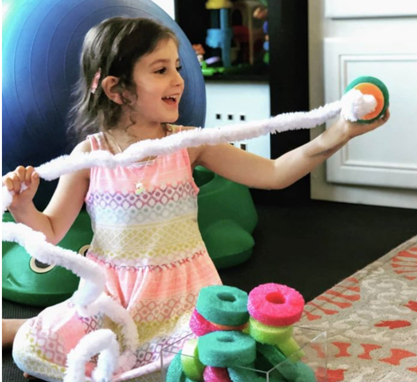 Using cut up pool noodles for gross motor beading.