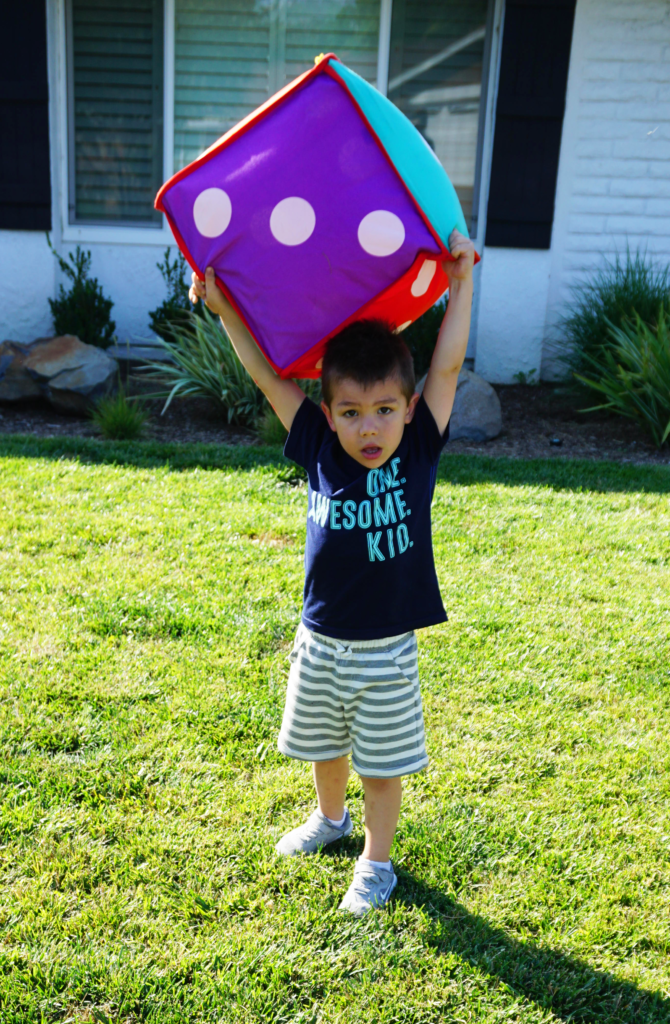 Throwing a large dice overhead like this helps work on skill building of range of motion and coordination. Plus what kid doesn't love when when ordinary items are extra large? 