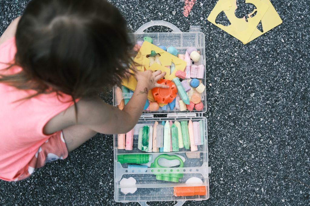 Using chalk for fine and gross motor development.